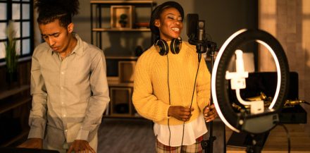 "Social Media for Musicians: Crafting a Comprehensive Strategy" - Female and male musicians recording a vlog at home